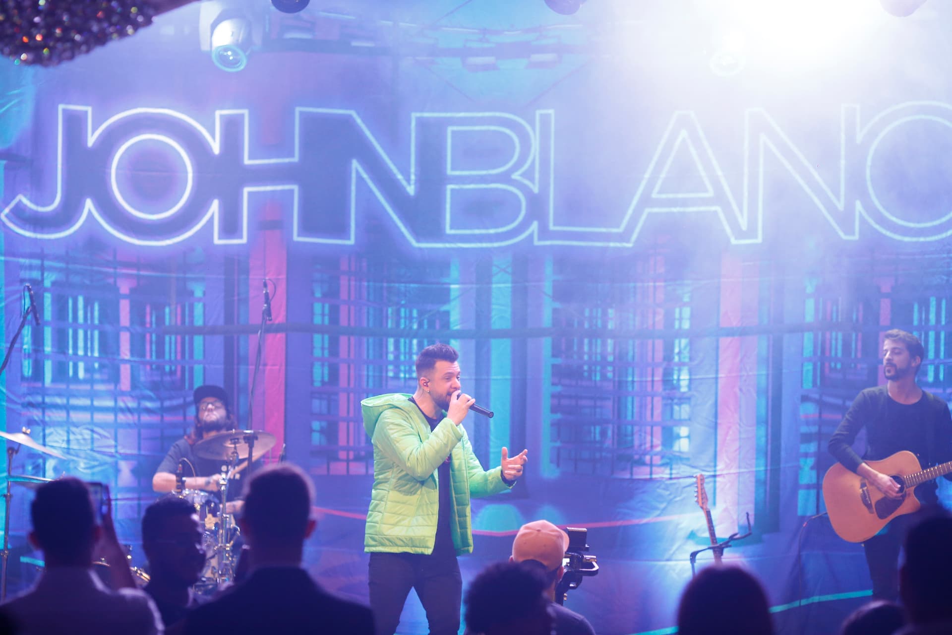 John Blanc em apresentação ao vivo com a banda e o público